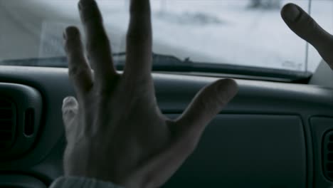 person driving in a car in winter