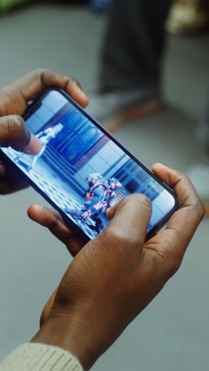 Person playing a mobile game on a smartphone
