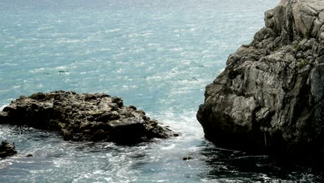 waves beating on the rocks on the beach in montenegro