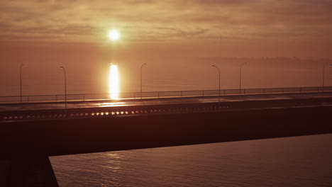 setting sun over water bridge