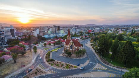 day to night time lapse view of traffic around historic landmark christ church aka christuskirche in windhoek, the capital and largest city of namibia