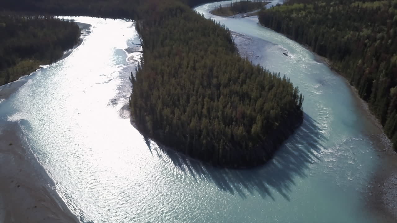 Slow aerial orbit of an extreme bend on the Saskatchewan River, aqua green waters, Alberta Canada.
