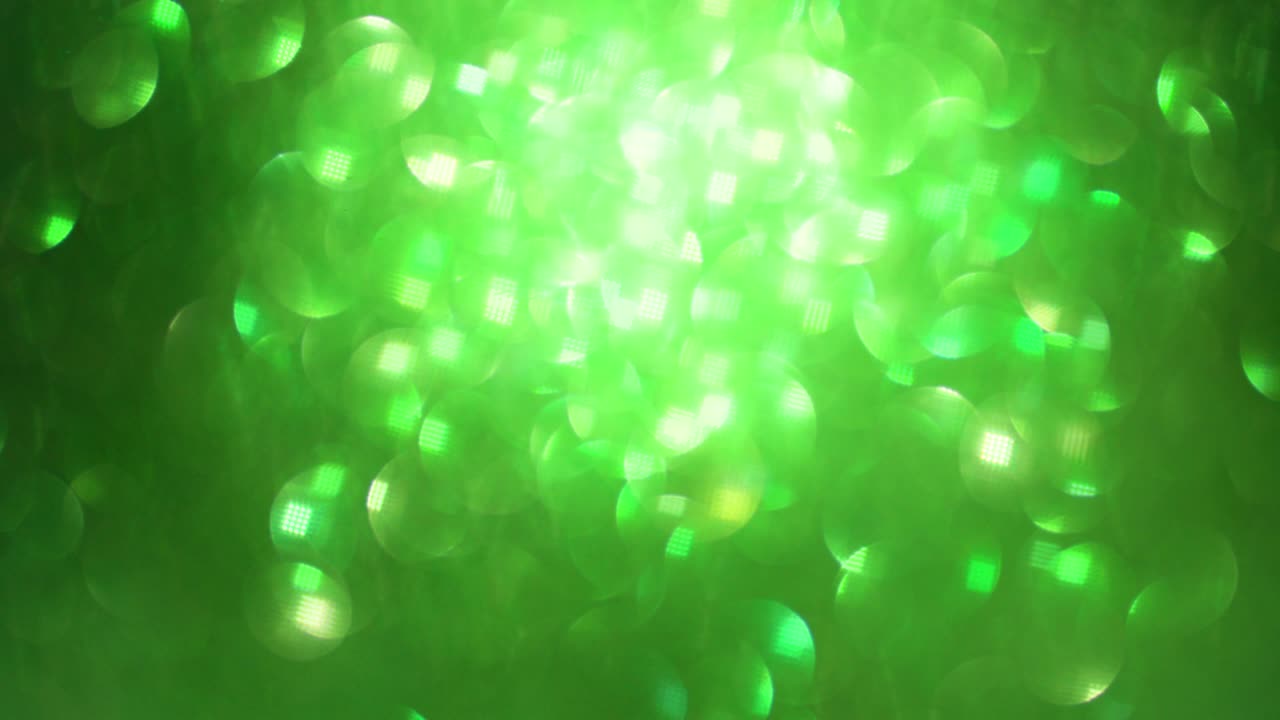 brillo verde, fondo bokeh abstracto, elegante de polvo de navidad. partículas brillantes brillantes. movimiento de movimiento brillante ligero.