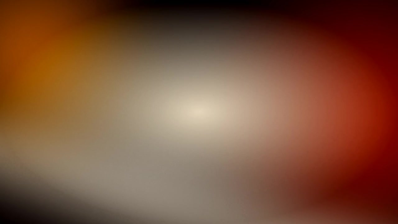 Transizione astratta con fughe di luce e toni caldi di rosso e arancione