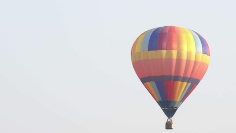 4k video tracking shot of colorful hot air balloons flying down in the air flight at spectacular white sky and green screen or chroma key background.