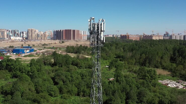 Cellular GSM tower with 3g, 5g transmitter. Communication antenna. Future technology. Aerial view from drone