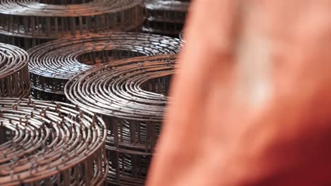 reveal of stacked wire mesh rolls on floor