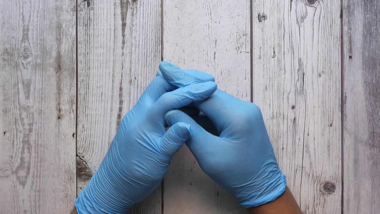 Hands in Blue Medical Gloves