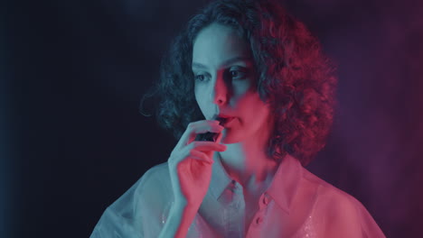 woman vaping in neon light