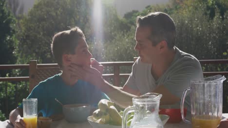 Family-eating-breakfast-together-outdoors