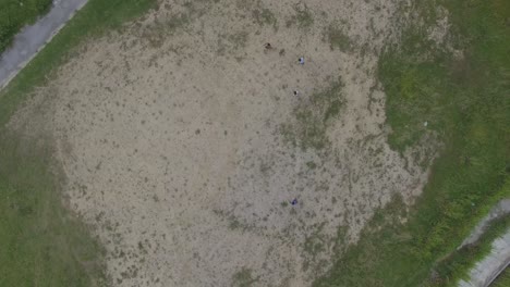 Aerial-view-of-kids-playing-in-a-playgroung-of-a-popular-slum-in-Caracas,-Venezuela