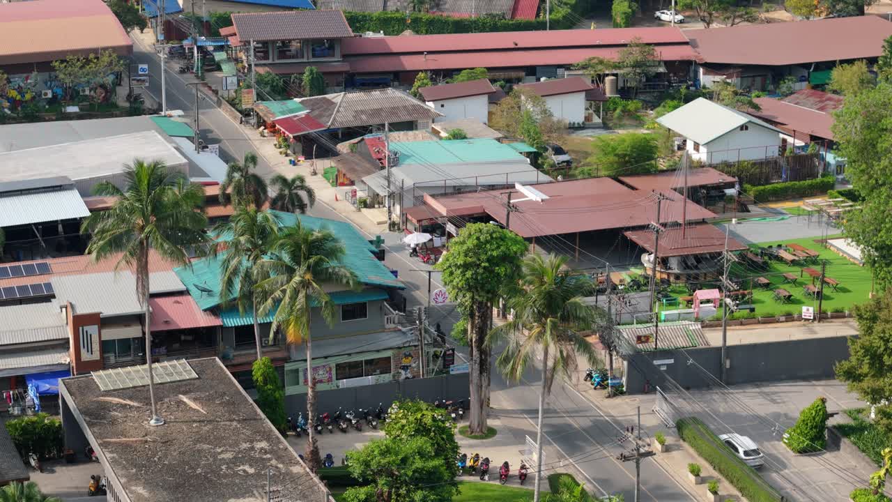 aerial drone footage of Koh Chang island, Kai Bae village with roads, shops, main road and roof tops