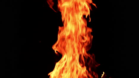 huge bonfire rising up in the darkness. dangerous red flame going up at night.