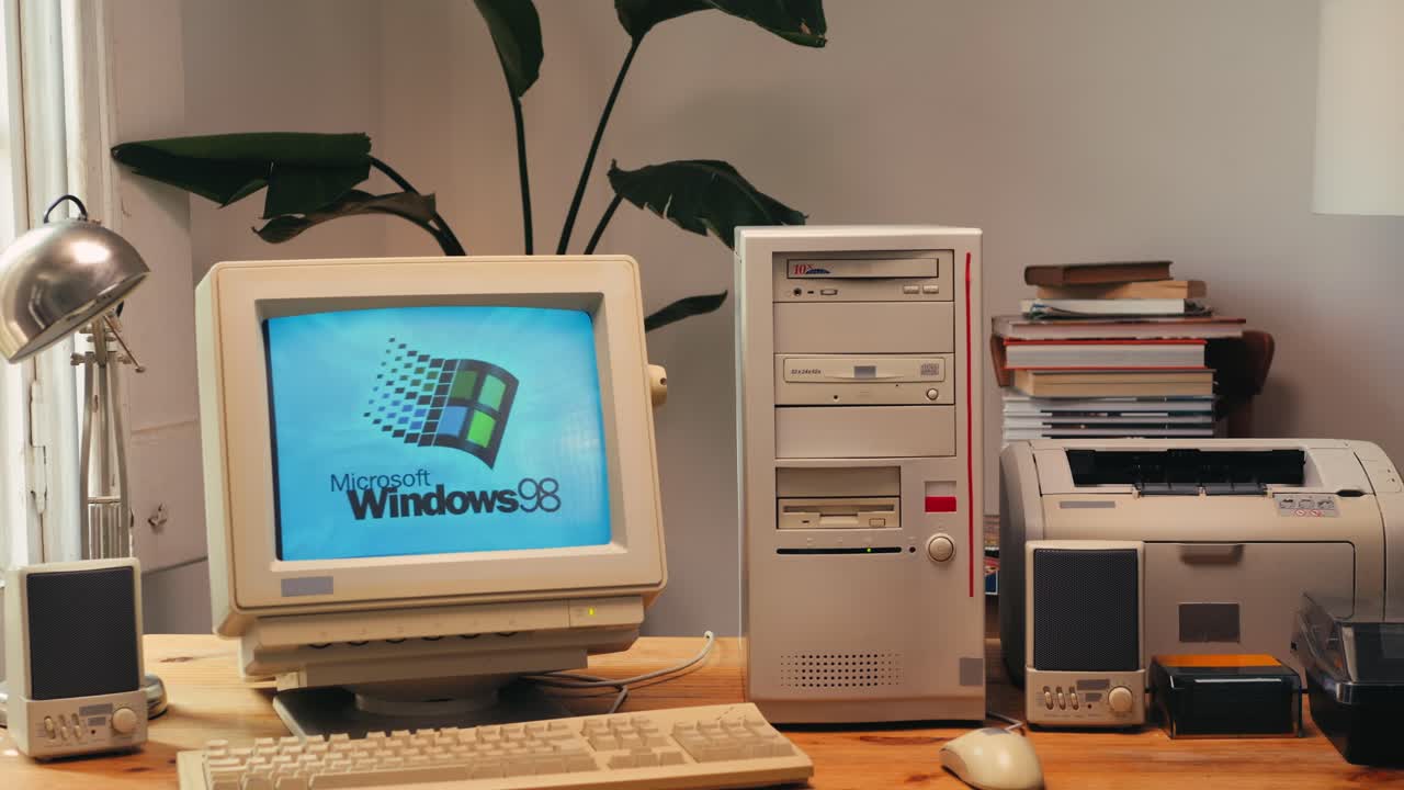 BARCELONA, SPAIN, 10 JUNE 2025. Man working and gaming on retro computer PC, IT engineer with vintage computer at home, using old fashion technology, close up of retro setup.