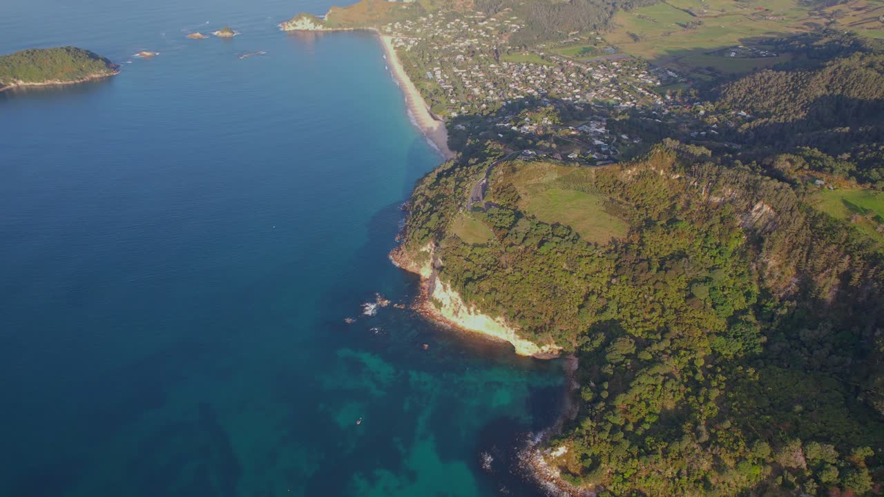 Aerial view of a coastline with turquoise water and green vegetation