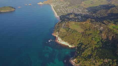 aerial view of a coastline with turquoise water and green vegetation