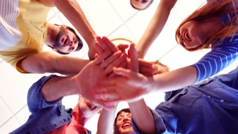 Upward-view-of-happy-executives-forming-handstack