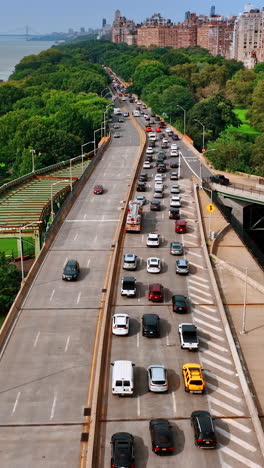 freeway along the waterfront of new york downtown. heavy traffic by one way of the road. top view. vertical video