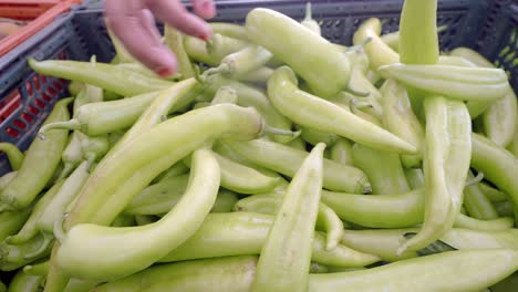 close up of green peppers in a crate