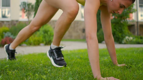 to complete the exercise of warm-up and warm-up muscles before training. a woman in the park in headphones performs a hitch with stretching after a successful fitness workout. restoring strength