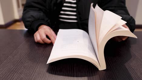 person flipping through a book's pages