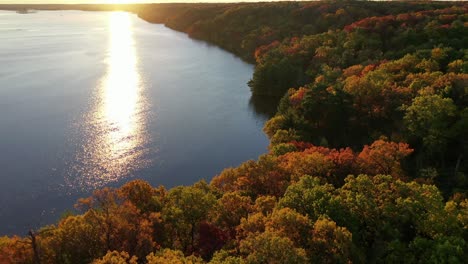 drone reveals shot of the illinois river bank during golden hour at starved rock state park