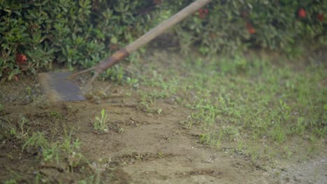 person using garden tool shovel to remove grass turf, slow motion