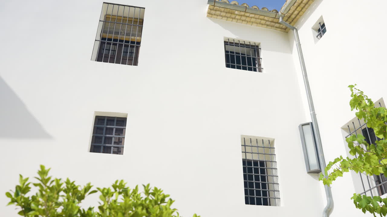 White Building with Barred Windows