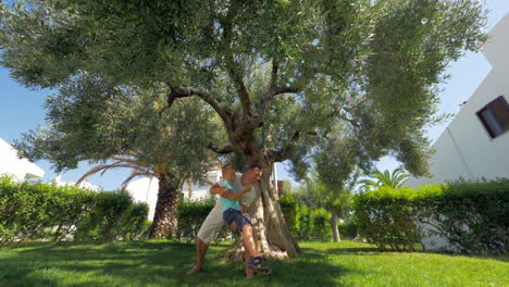 dad with son having fun in the garden on summer day