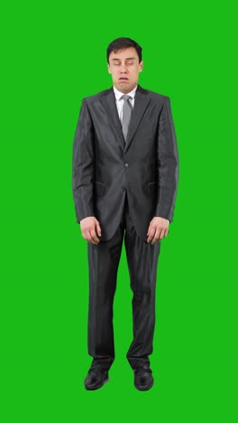 man in suit pinches nose reacting to bad smell on green screen