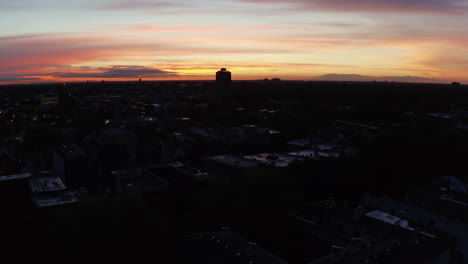 Drone-Flight-Above-Urban-City-at-Sunset