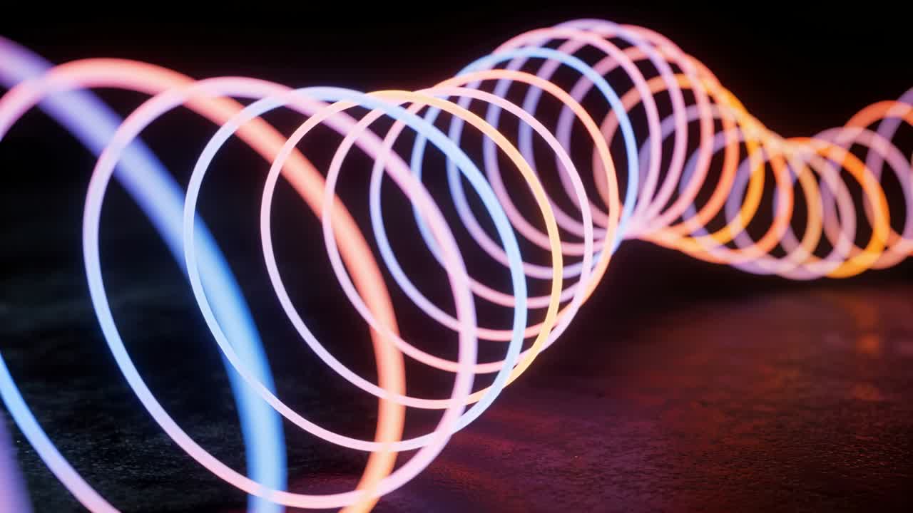 Playback starting, glowing concentric rings helix shifting forward in dark studio, showing gradient