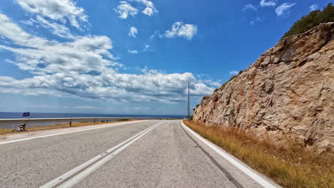 Drivers-view-of-driving-on-mountain-road-on-a-sunny-day-in-Greece