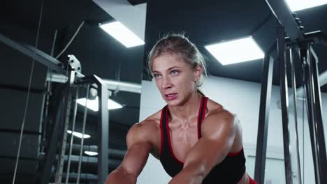 woman working out on a cable machine in a gym
