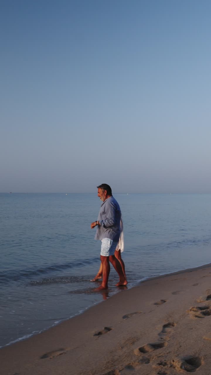 Couple enjoying a walk on the beach
