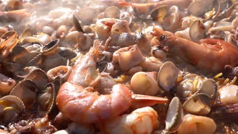 Cooking-a-delicious-paella,-shrimp,-seafood,-lobster