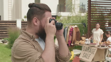 cheerful man with photo camera posing