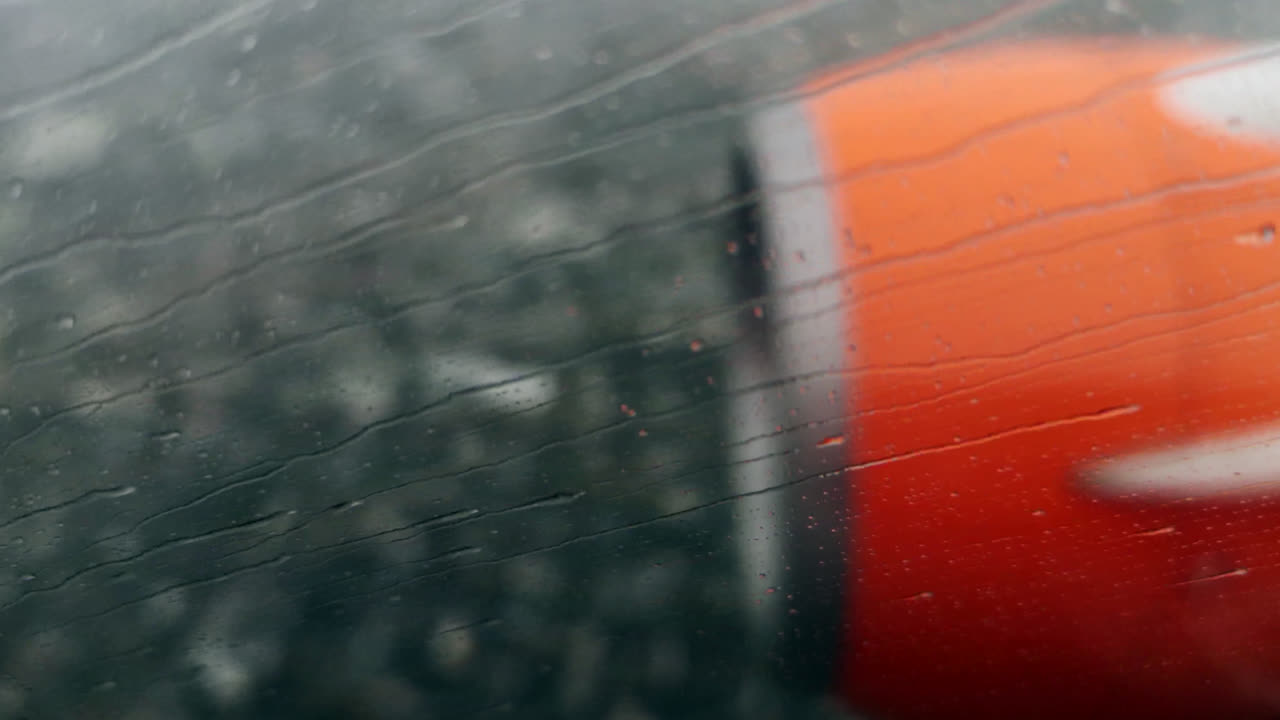Aeroplane engine, raining on window while flying