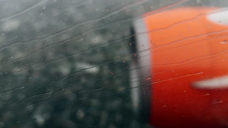 aeroplane engine, raining on window while flying