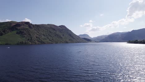 Low-drone-shot-flying-forward-over-Ullswater-on-a-sunny-day,-Lake-District,-Cumbria,-UK