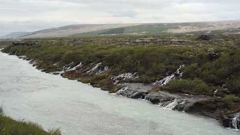 Panning-view-of-the-extraordinary-waterfall-Barnafoss-and-its-rivers-located-in-Iceland,-Europe