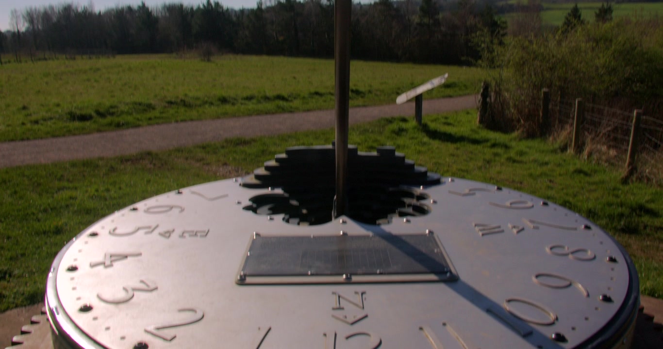 mid Tilting down shot of the Bettisfield Mining Memorial Sundial