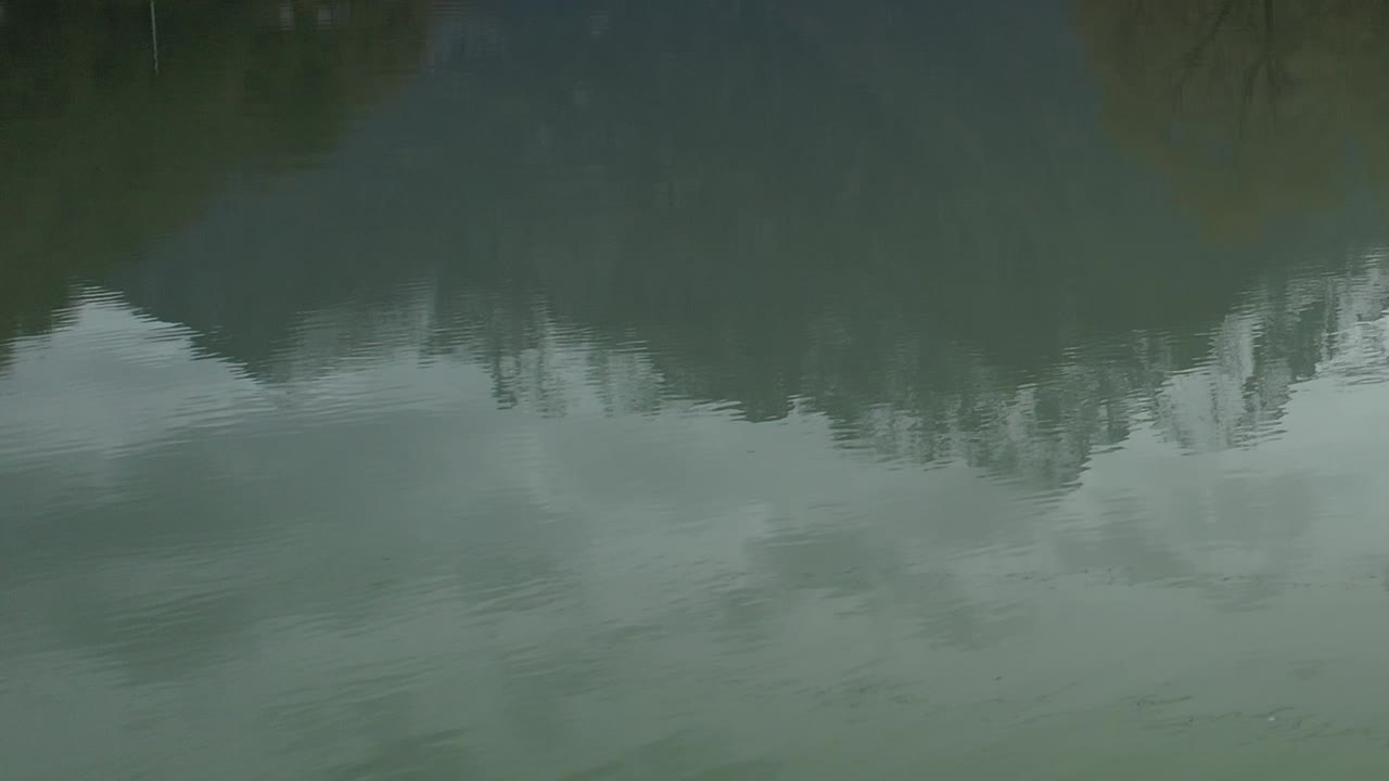 Aerial view over calm waters reflecting the Alps in Italy