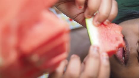 close-up of a person eating watermelon