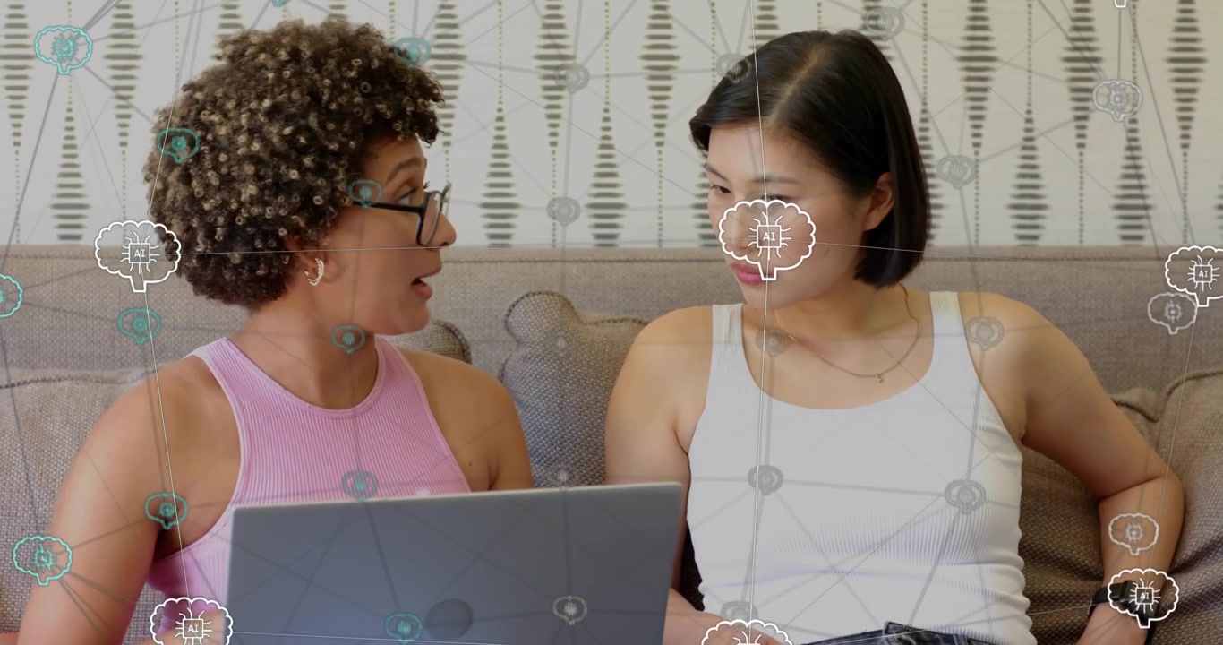 Women coworkers opening laptop and typing for business review while pointing and navigating content