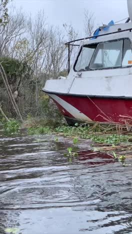 scuba diving boat washed ashore during hurricane storm surge, water floods