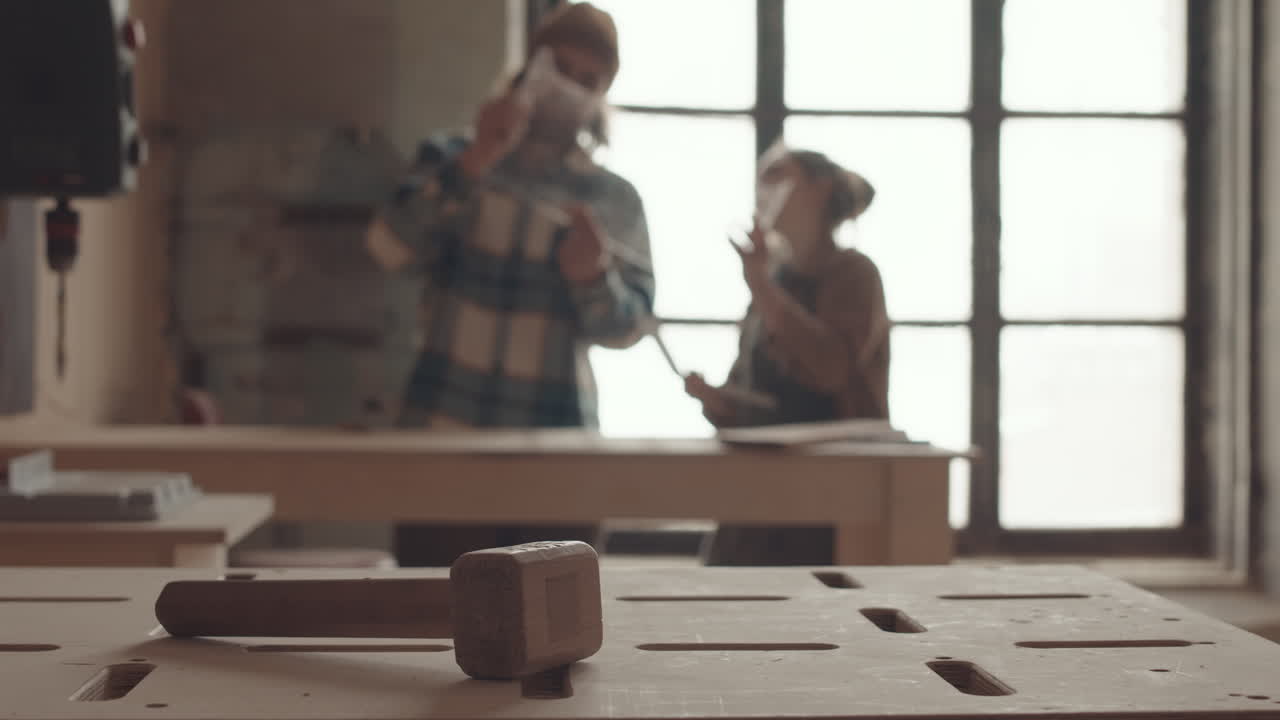 Two Joiners Working Together in Carpentry Workshop