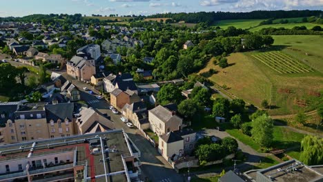 smooth upward drone movement over the countryside environment of changé commune with green fields, mayenne, france