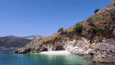 retreating drone shot of a secluded agriosiko beach in cephalonia, located in the ionian islands off the coast of greece