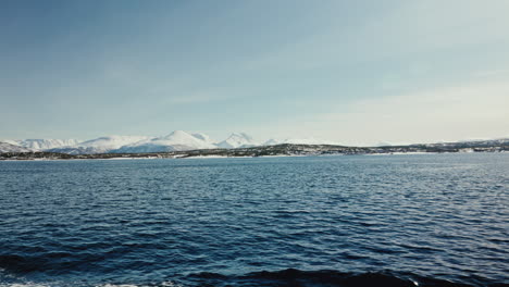 Wide-Static-Shot-of-Boat-Cruise-Sailing-along-the-Arctic-Fjords-in-Norway